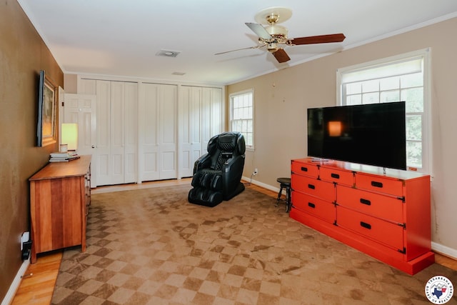 3519 Olive St, Texarkana, TX 75503 - living area featuring ceiling fan, healthy amount of natural light, light wood-style flooring, baseboards, and crown molding