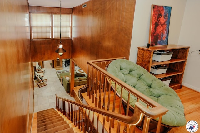 3519 Olive St, Texarkana, TX 75503 - stairway with wood walls, wood finished floors, and baseboards