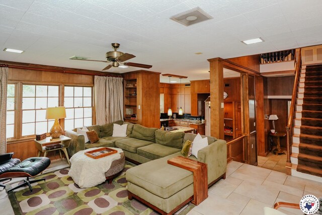 3519 Olive St, Texarkana, TX 75503 - living area featuring stairs, ceiling fan, light tile patterned floors, and wooden walls