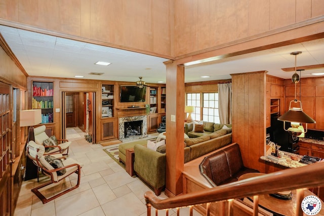 3519 Olive St, Texarkana, TX 75503 - living area with a high end fireplace, built in features, light tile patterned floors, wood walls, and ornamental molding