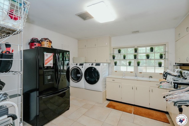 3519 Olive St, Texarkana, TX 75503 - laundry area with washer and dryer, light tile patterned floors, and cabinet space