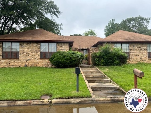 310-312 Brookwood Dr, Texarkana, TX 75501 - single story home featuring brick siding and a front lawn