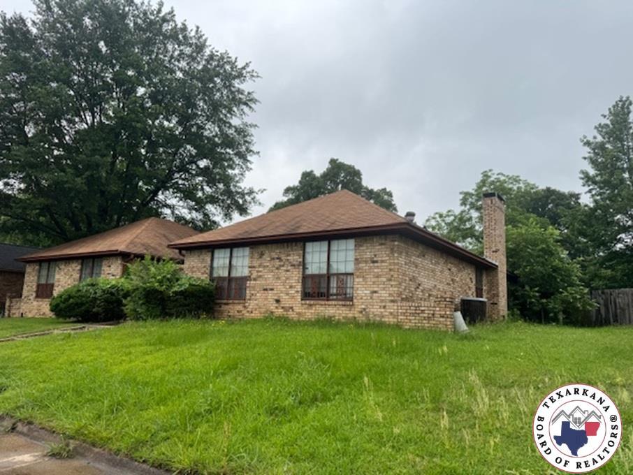 310-312 Brookwood Dr, Texarkana, TX 75501 - view of side of home with a chimney, brick siding, and central air condition unit