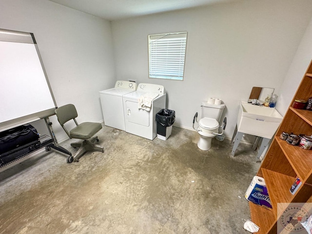 bathroom featuring sink, concrete floors, and separate washer and dryer