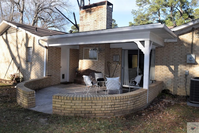 rear view of property with a patio and central AC