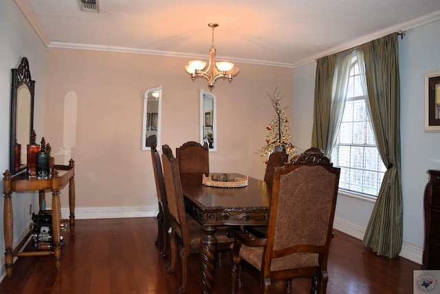 dining room with a chandelier, ornamental molding, and dark hardwood / wood-style floors