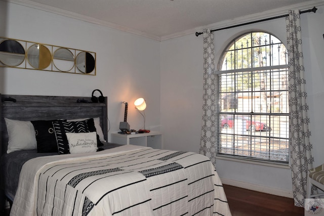 bedroom with ornamental molding, dark hardwood / wood-style floors, and multiple windows