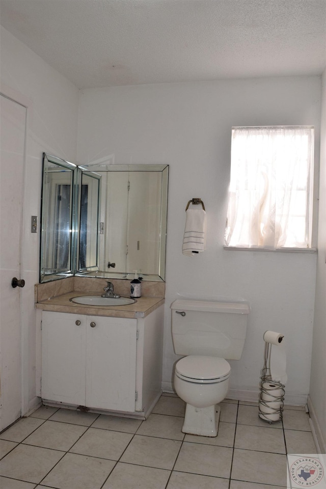 712 Diane Dr, Wake Village, TX 75501 - bathroom featuring toilet, tile patterned flooring, vanity, and a textured ceiling