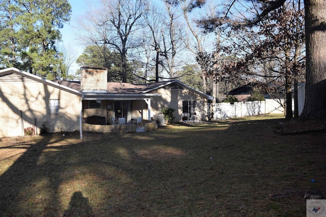 back of property featuring central AC unit and a yard