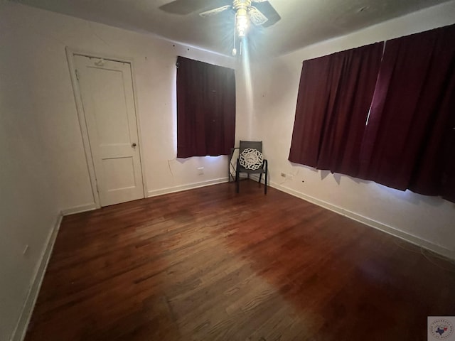 spare room featuring ceiling fan and dark hardwood / wood-style floors