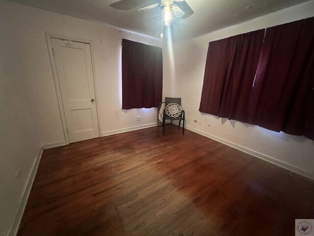 spare room featuring ceiling fan and dark hardwood / wood-style floors