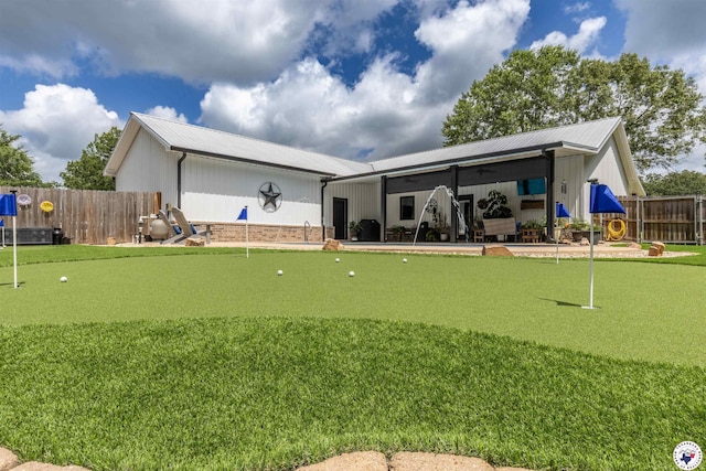 113 Dove Crk, New Boston, TX 75570 - rear view of house featuring a putting green and a metal roof