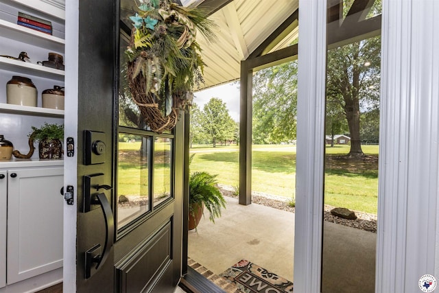 113 Dove Crk, New Boston, TX 75570 - doorway to outside featuring vaulted ceiling and carpet flooring