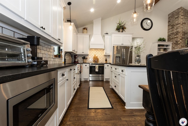 113 Dove Crk, New Boston, TX 75570 - kitchen featuring stainless steel appliances, lofted ceiling, decorative backsplash, dark countertops, and white cabinetry