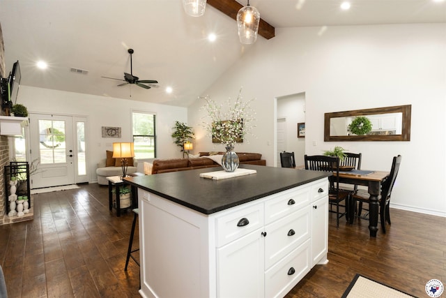113 Dove Crk, New Boston, TX 75570 - kitchen with dark countertops, dark wood-style floors, a kitchen island, beam ceiling, and ceiling fan