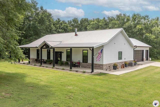 113 Dove Crk, New Boston, TX 75570 - back of house with a yard, concrete driveway, a garage, and a metal roof