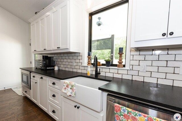 113 Dove Crk, New Boston, TX 75570 - kitchen with appliances with stainless steel finishes, dark countertops, white cabinetry, and tasteful backsplash