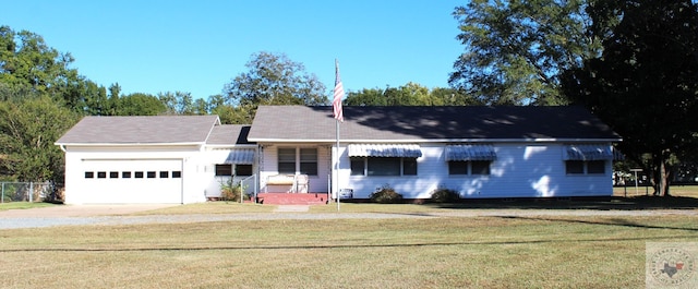 ranch-style house featuring a front yard and a garage