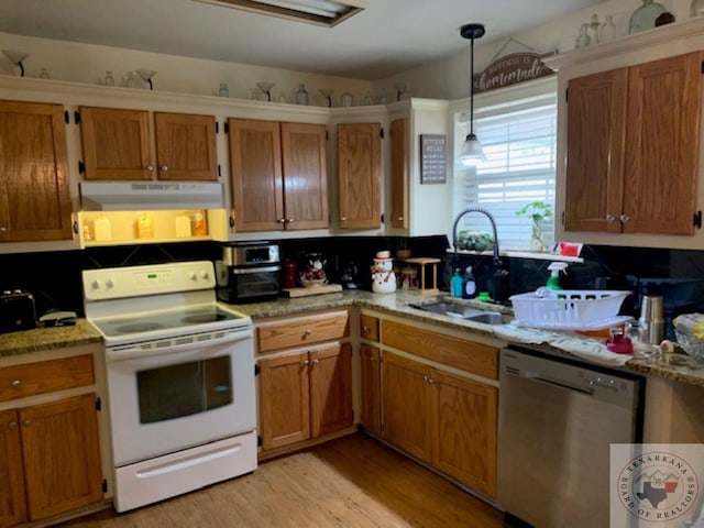 kitchen featuring stainless steel dishwasher, light hardwood / wood-style flooring, hanging light fixtures, sink, and white electric range