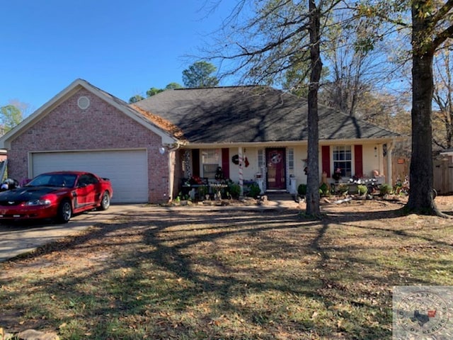 ranch-style home with a garage and a front lawn