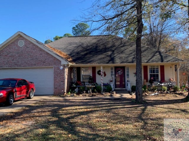 single story home with a front yard and a garage