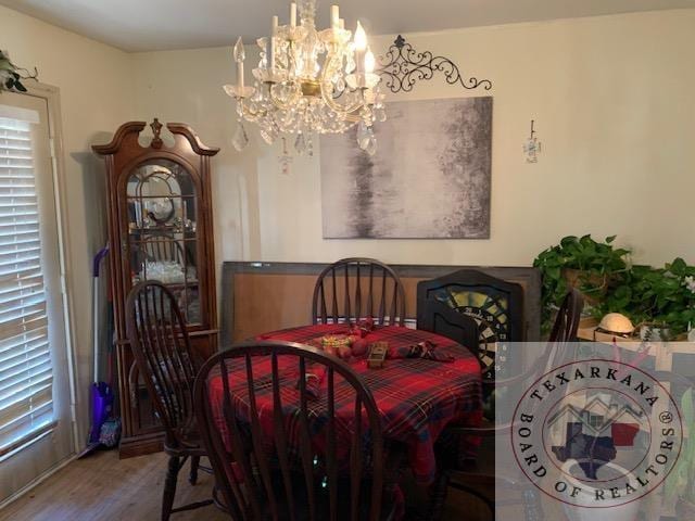 dining room with a chandelier and hardwood / wood-style floors