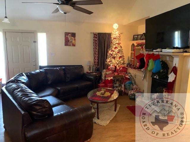 living room with light wood-type flooring and ceiling fan