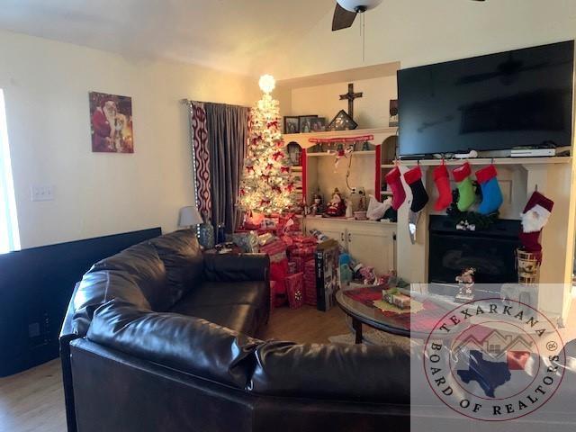 living room featuring ceiling fan and wood-type flooring