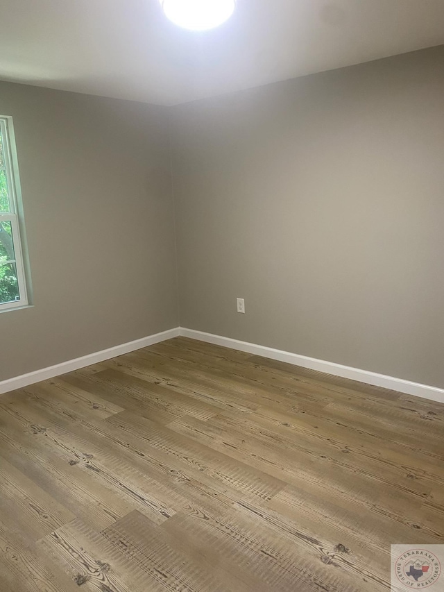 spare room featuring hardwood / wood-style floors