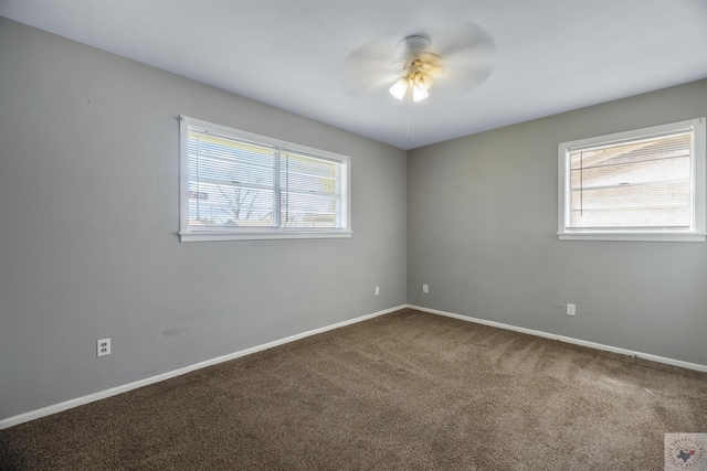 carpeted empty room with ceiling fan and plenty of natural light