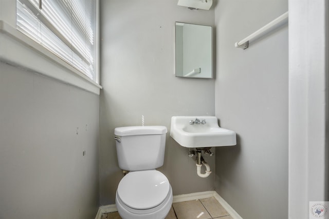 bathroom featuring sink, toilet, and tile patterned floors