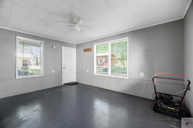 empty room featuring ceiling fan, plenty of natural light, and ornamental molding