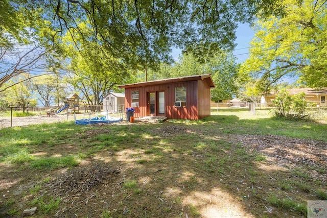 view of yard featuring a playground and an outdoor structure