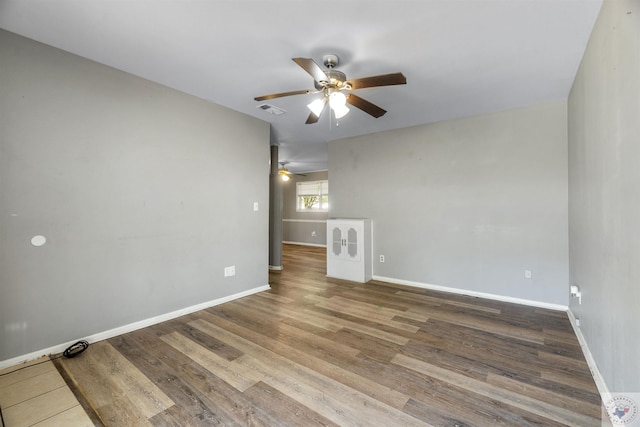 spare room with ceiling fan and wood-type flooring