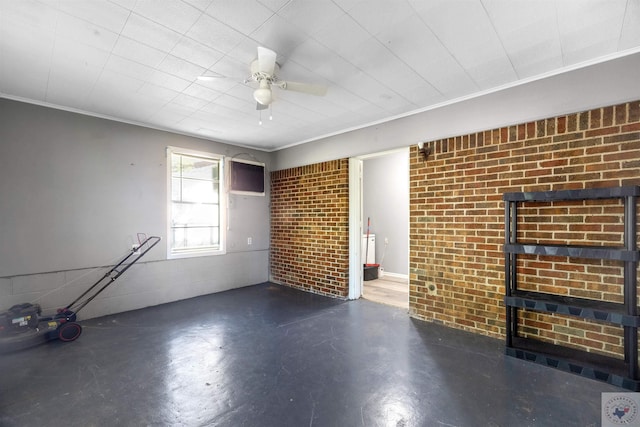 unfurnished living room featuring ceiling fan, brick wall, and ornamental molding