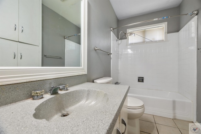 full bathroom featuring vanity, toilet, tile patterned floors, and tiled shower / bath combo