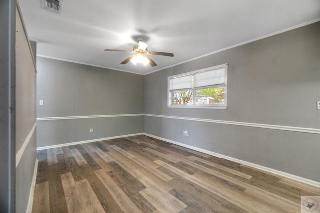 empty room with ceiling fan, hardwood / wood-style floors, and crown molding