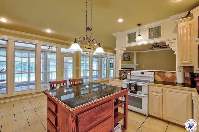 142 Easy St, Texarkana, TX 75503 - kitchen featuring range with two ovens, ceiling fan, ornamental molding, light tile patterned flooring, and tasteful backsplash