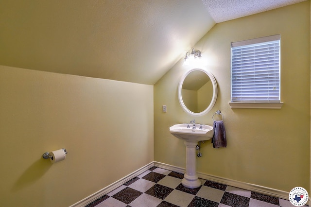 142 Easy St, Texarkana, TX 75503 - bathroom with tile patterned floors, vaulted ceiling, and baseboards