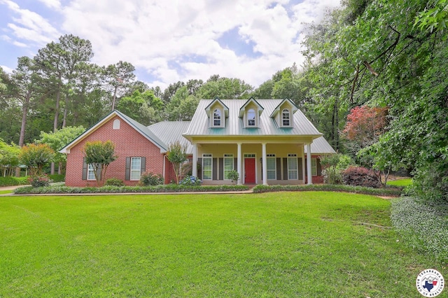 142 Easy St, Texarkana, TX 75503 - new england style home with a front yard, covered porch, metal roof, and brick siding