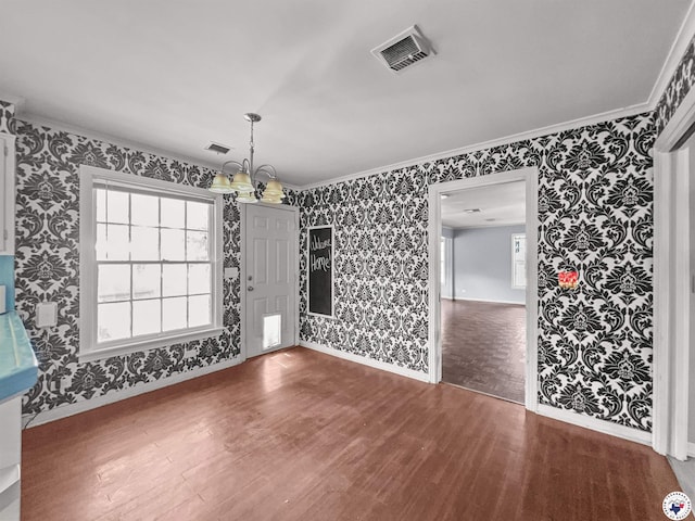 3223 Walnut St, Texarkana, TX 75503 - unfurnished dining area featuring wallpapered walls, wood finished floors, and crown molding