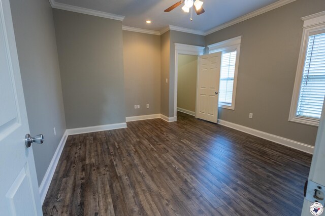 unfurnished bedroom featuring multiple windows and dark wood-type flooring