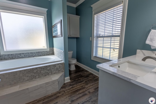 bathroom with toilet, a healthy amount of sunlight, a bath, and wood finished floors