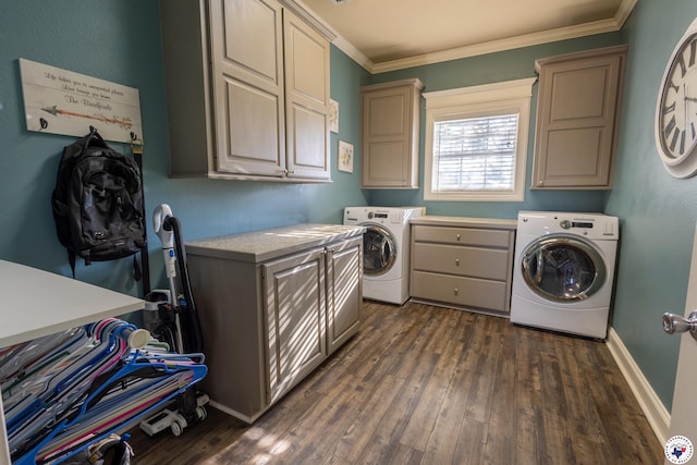 clothes washing area featuring crown molding, dark wood finished floors, cabinet space, baseboards, and washer and clothes dryer