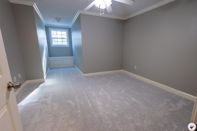interior space featuring crown molding, baseboards, and a ceiling fan