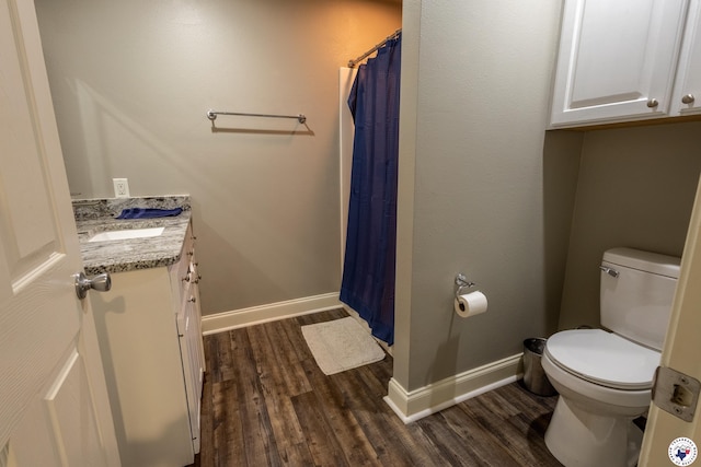 full bath featuring baseboards, vanity, toilet, and wood finished floors