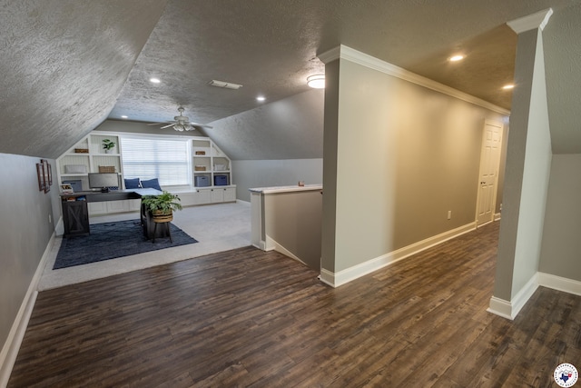 bonus room featuring visible vents, wood finished floors, baseboards, a textured ceiling, and vaulted ceiling