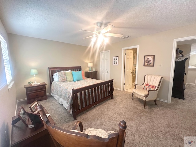 carpeted bedroom with multiple windows, a textured ceiling, and ceiling fan