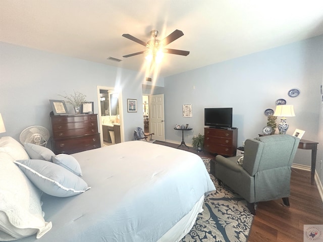 bedroom featuring dark wood-type flooring, ensuite bathroom, and ceiling fan