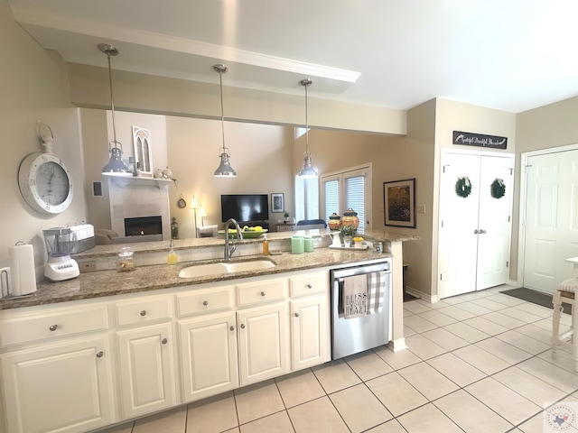 kitchen with sink, dishwasher, white cabinets, and stone counters